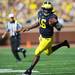 Michigan senior quarterback Denard Robinson runs the ball for yards after losing a shoe in the first quarter against UMass at Michigan Stadium on Saturday. Melanie Maxwell I AnnArbor.com